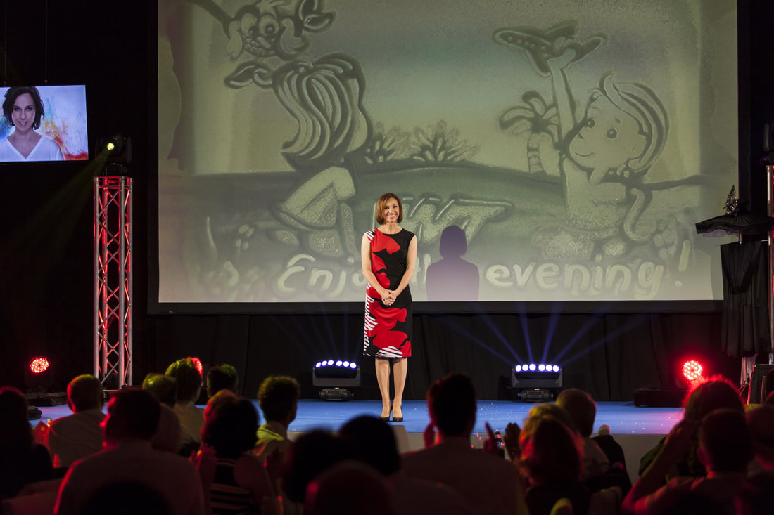 Sand Painter Katrin Weissensee performing at the WNT company celebration in Reutte (Austria)